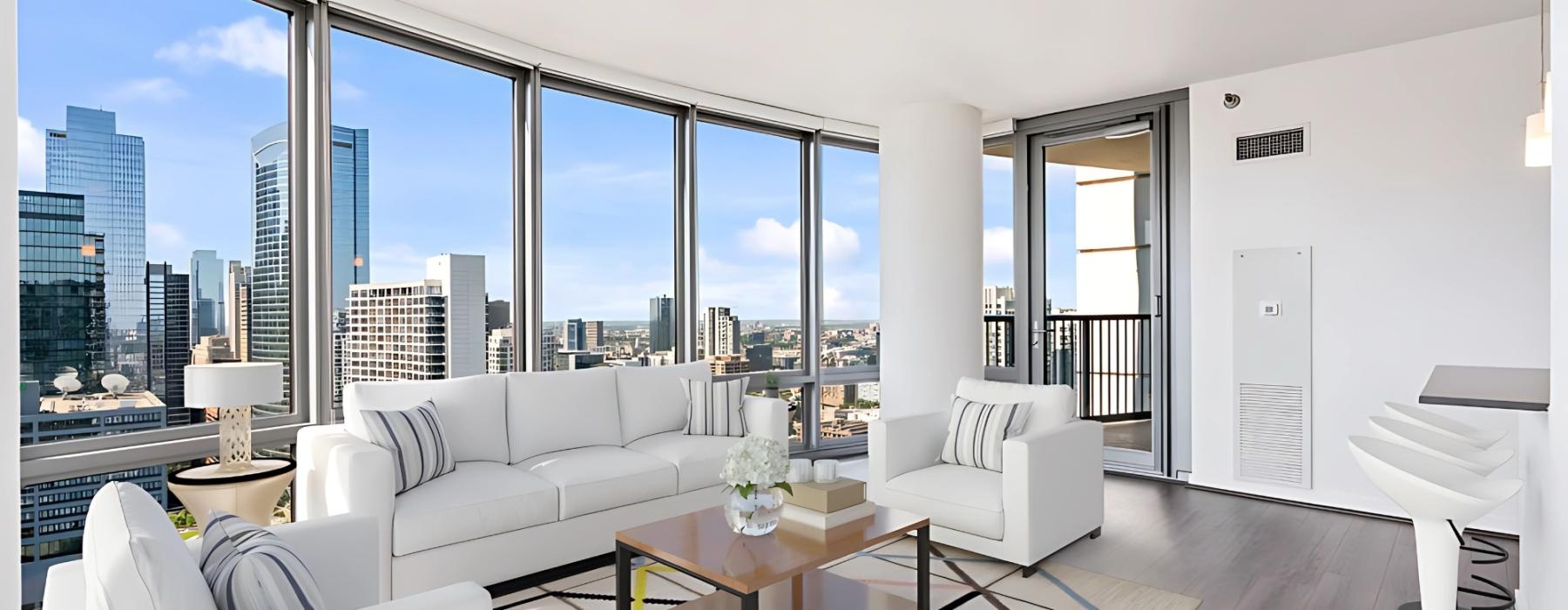 a room with a large window and a large white couch