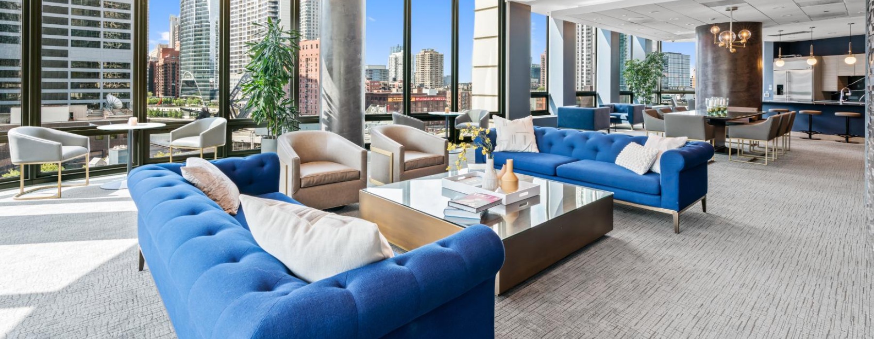 a room with a large window and a large blue couch