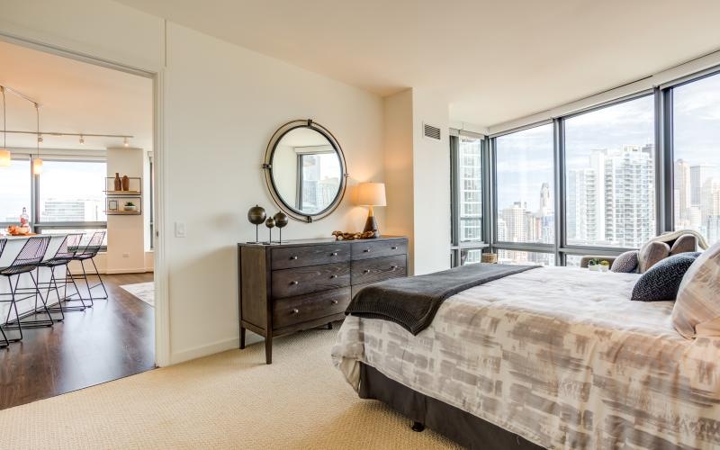 a bedroom with a bed and a mirror