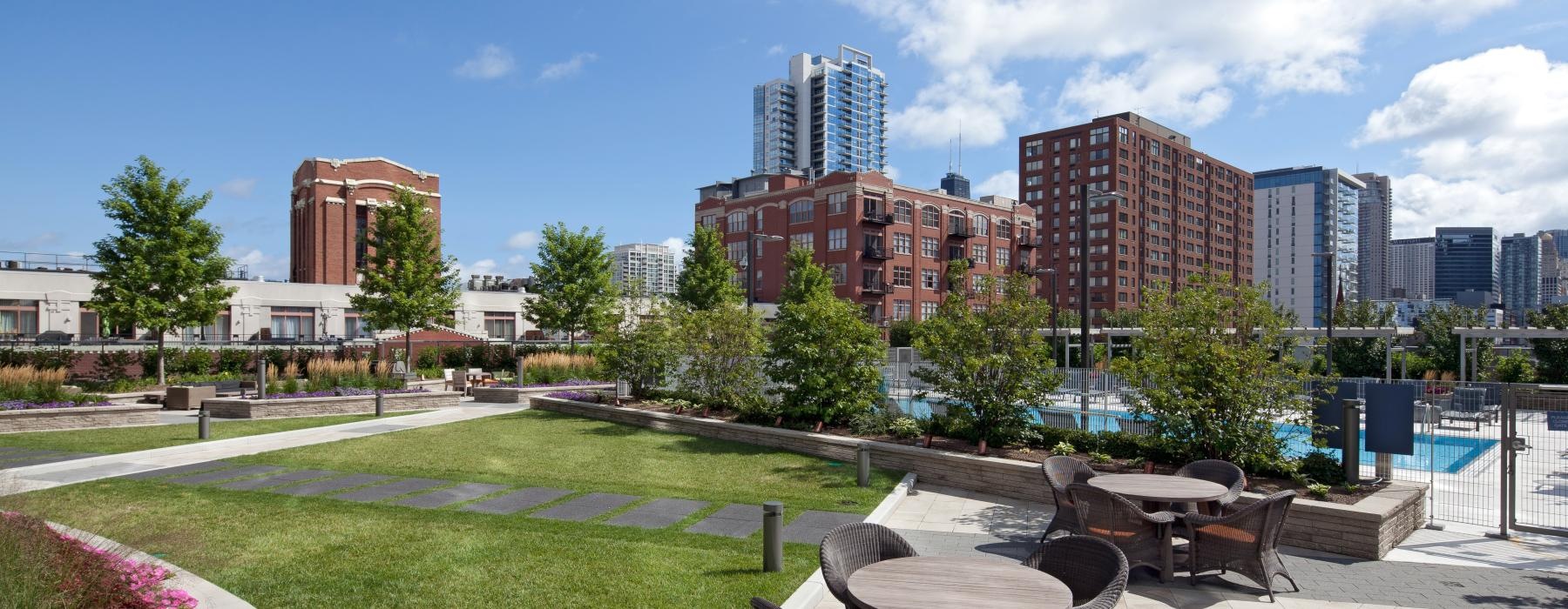 a patio with a table and chairs and a large city landscape