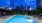 a swimming pool with a city in the background